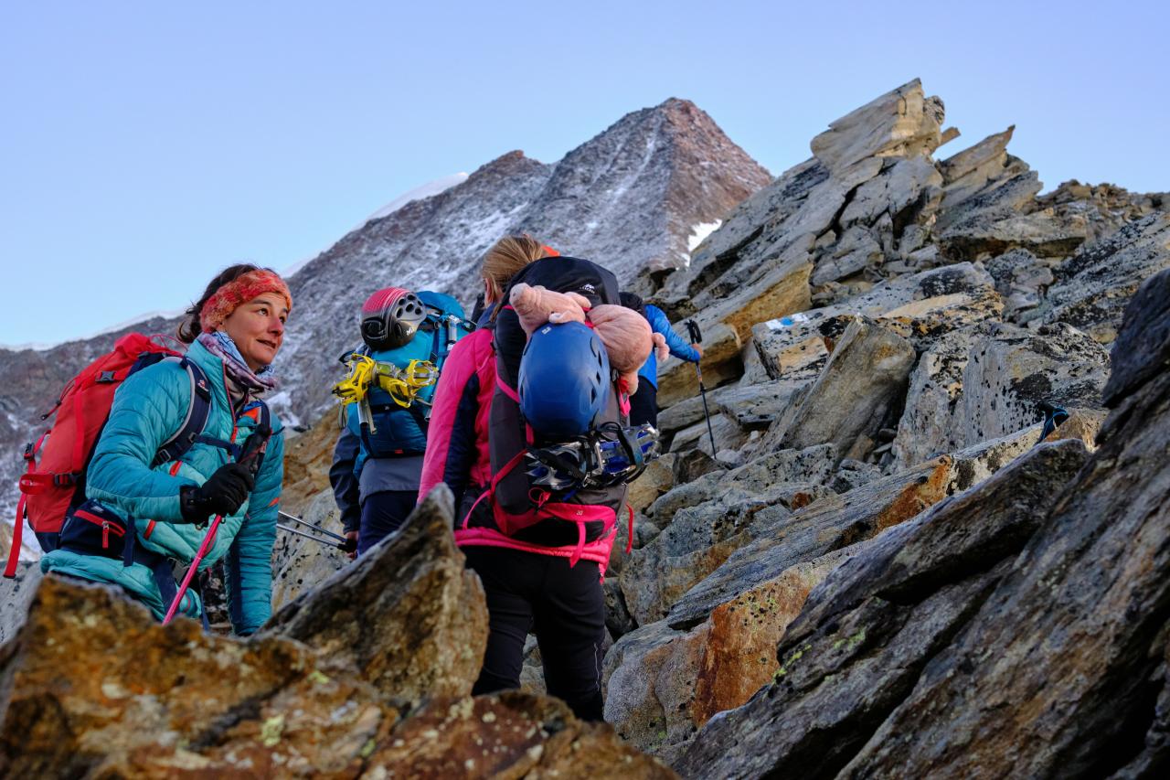 people hiking on rocky mountain during daytime
